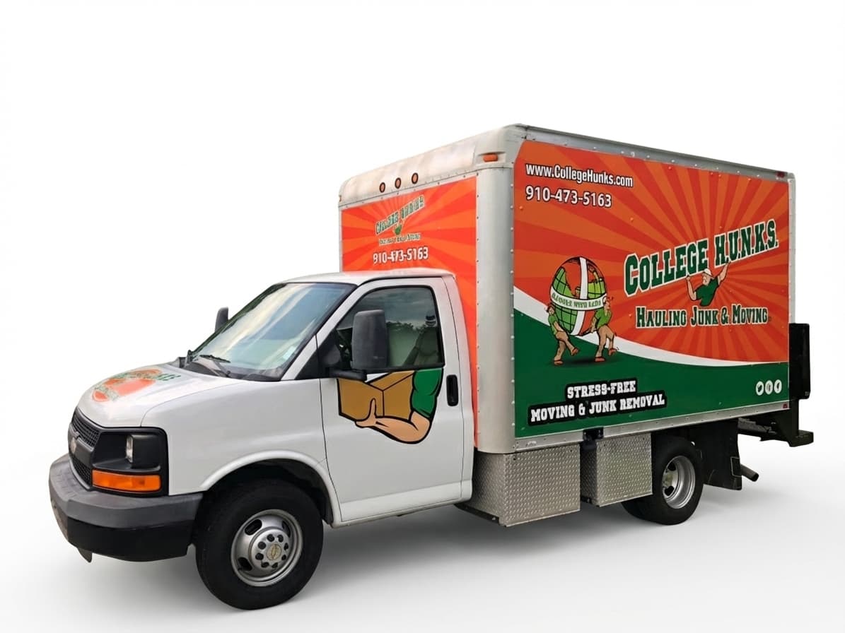 A white box truck featuring a vibrant orange and green College Hunks Hauling Junk & Moving vehicle wrap.