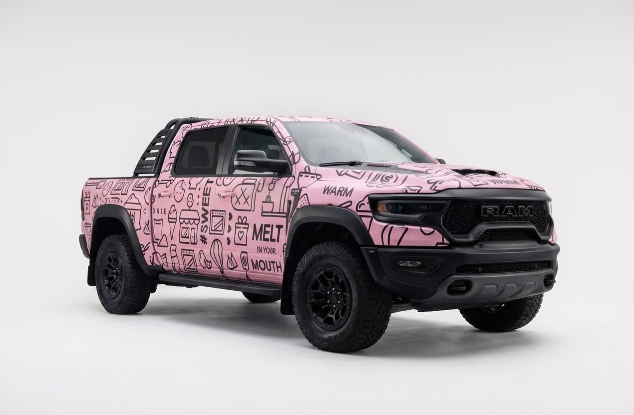 RAM pickup truck with a pink Crumbl Cookies themed custom vehicle wrap.