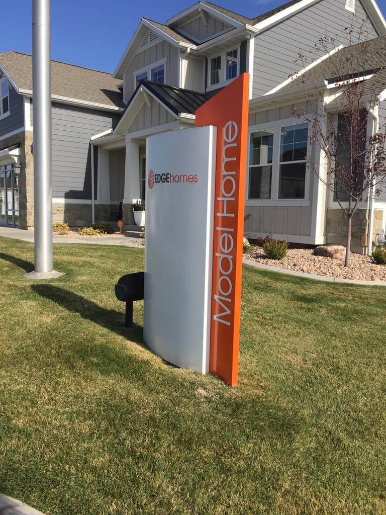 Edge Homes monument sign for a Model Home in front of a residential house.