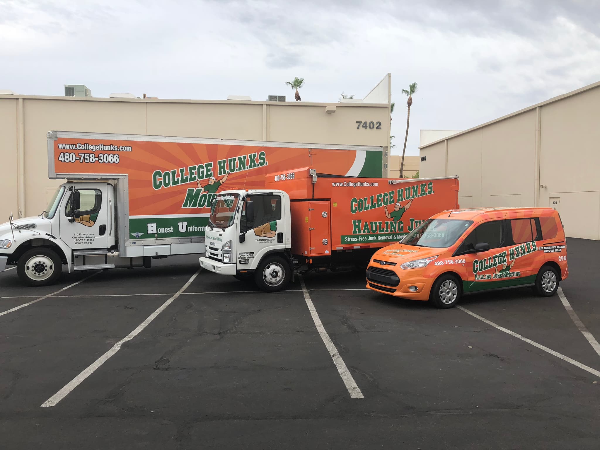 Three College Hunks Hauling Junk vehicles featuring bright orange and green custom vinyl wraps parked in a lot.
