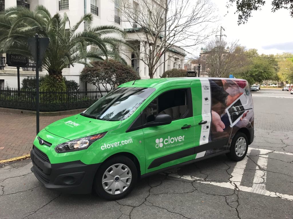 Green Ford Transit van custom wrapped with Clover A First Data Company branding.