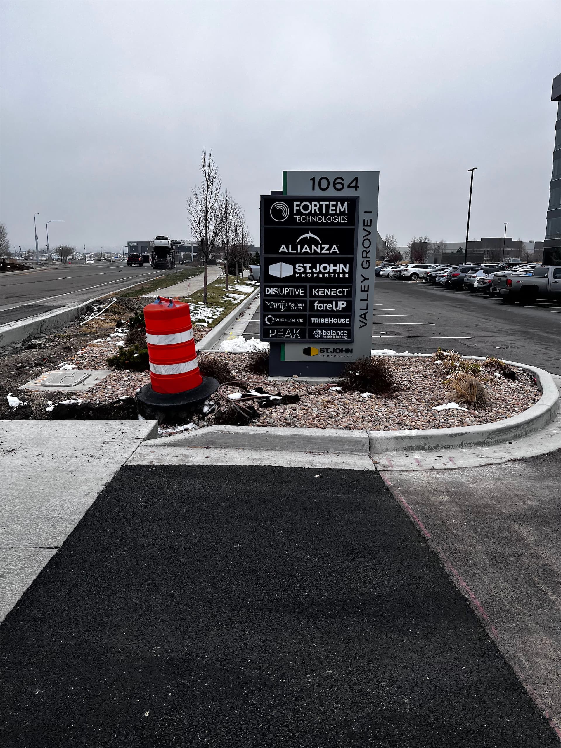 Outdoor monument tenant directory sign for Valley Grove I featuring St. John Properties and business logos.
