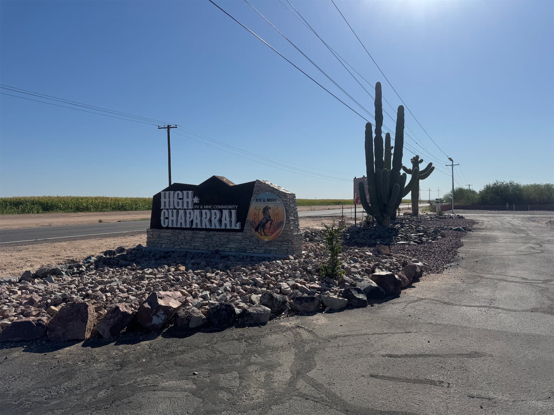 High Chaparral RV & MHC Community stone monument entrance sign surrounded by cacti.