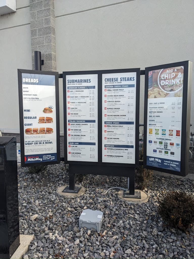 Outdoor drive-thru menu board displays for Jersey Mike's Subs.