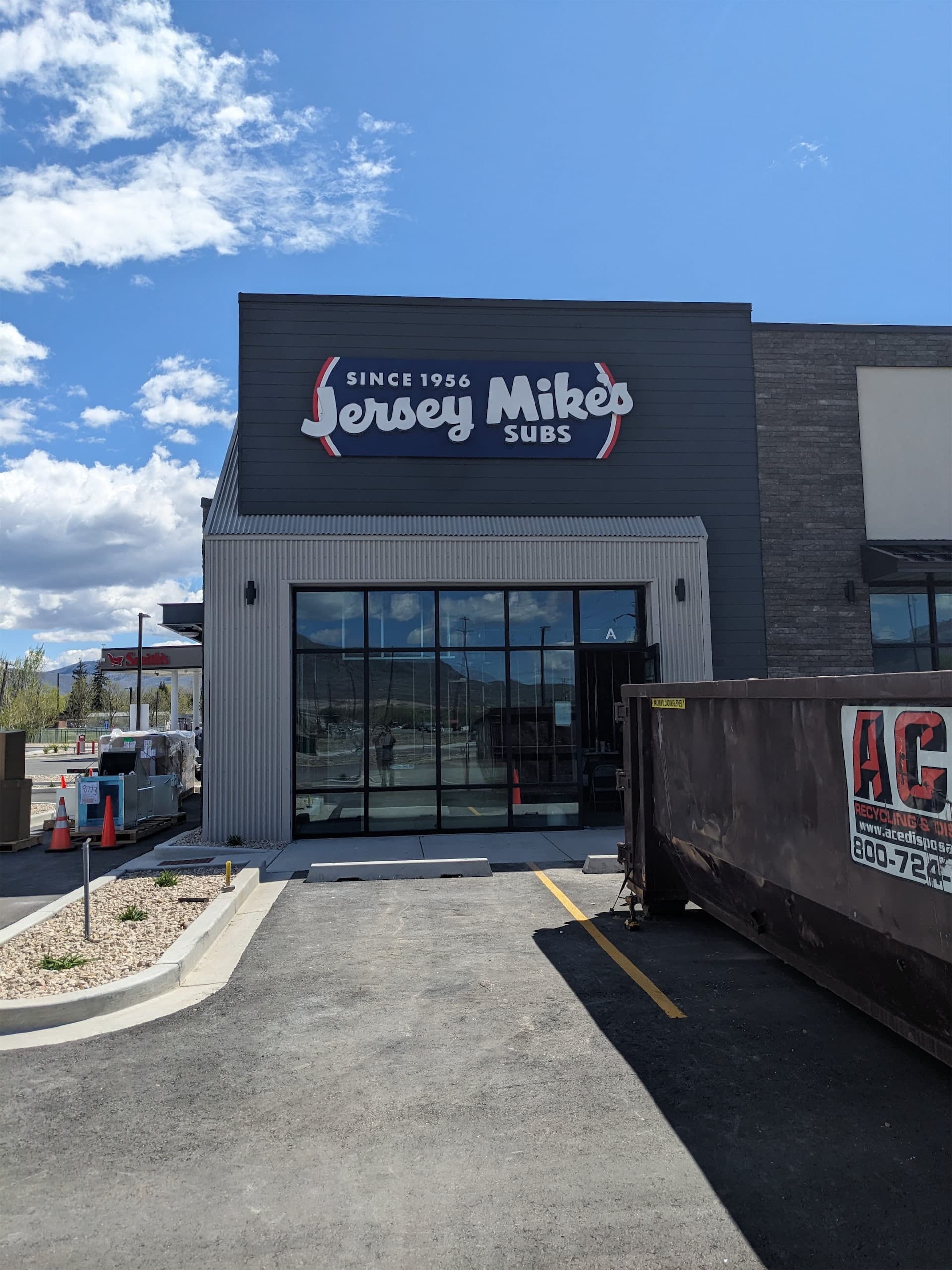 Exterior view of a Jersey Mike's Subs storefront featuring a newly installed illuminated building sign.