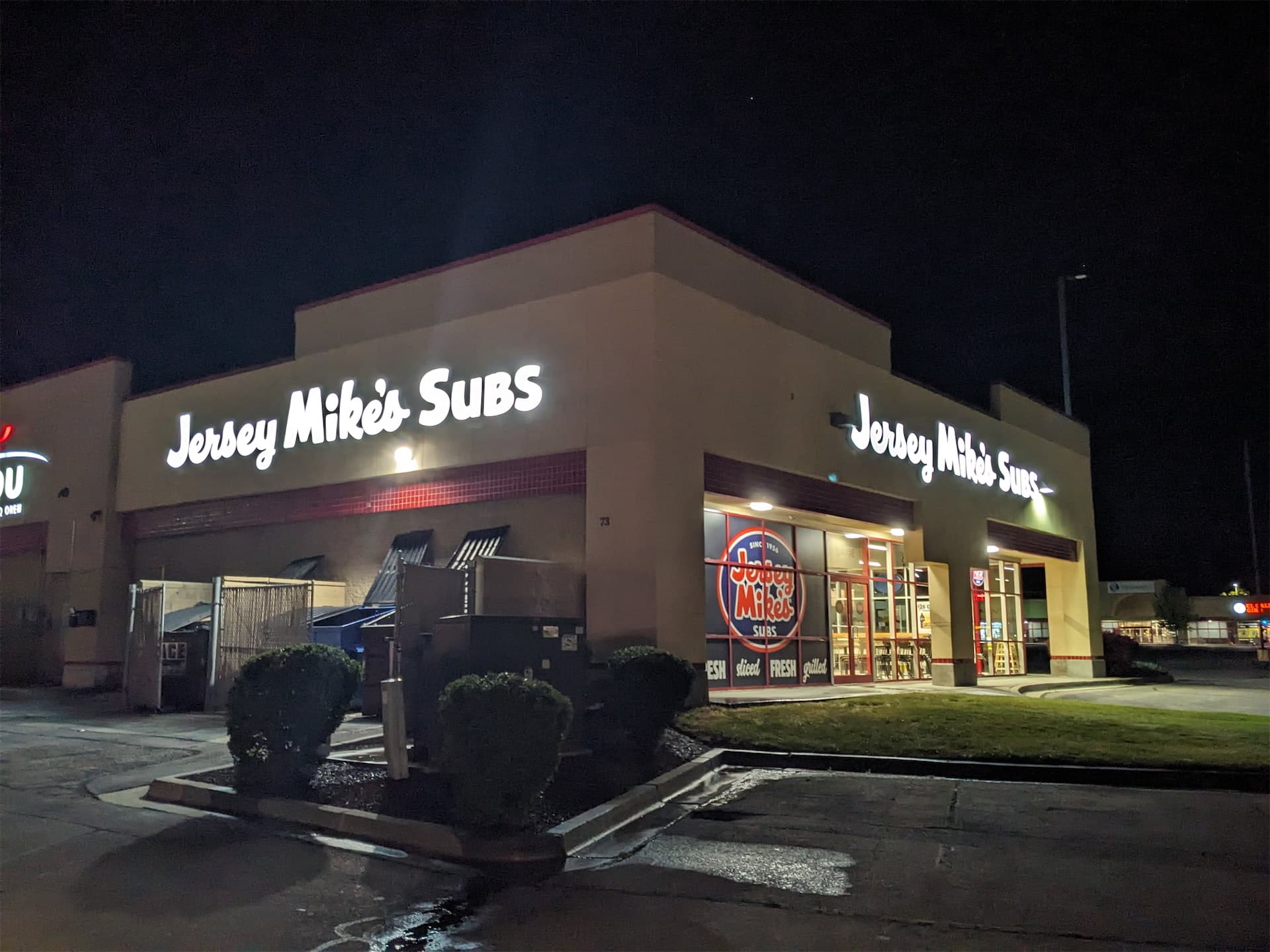 Illuminated Jersey Mike's Subs electric channel letter signs on a building exterior at night.
