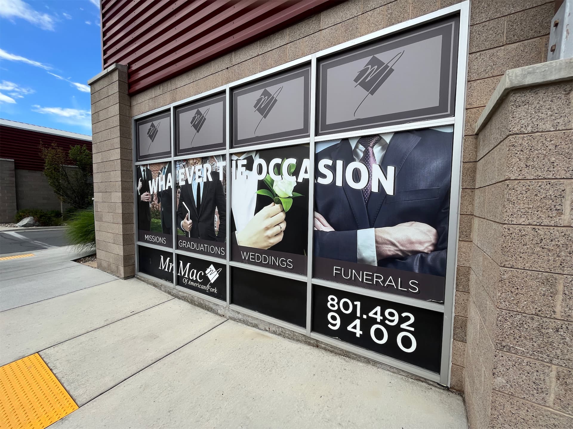 Storefront windows with custom printed vinyl graphics for Mr. Mac retail store in American Fork.