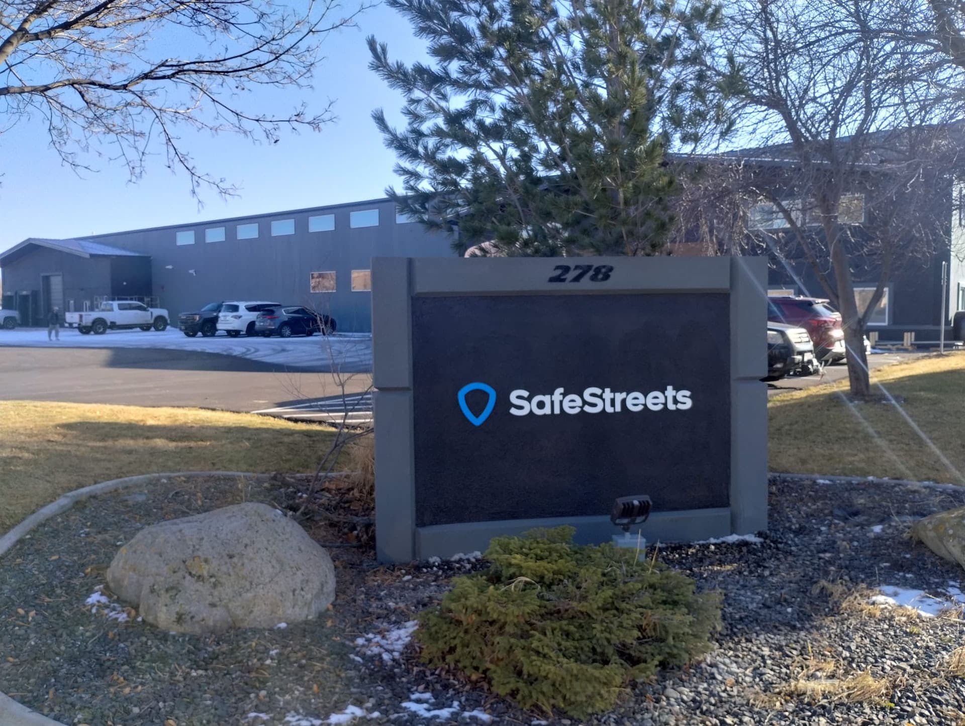 Exterior SafeStreets monument sign standing in front of an office building.