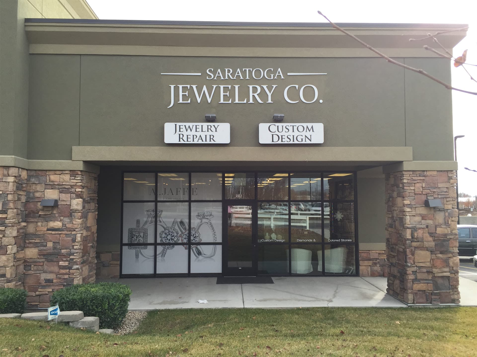 Storefront of Saratoga Jewelry Co. featuring custom exterior building signage and window graphics.