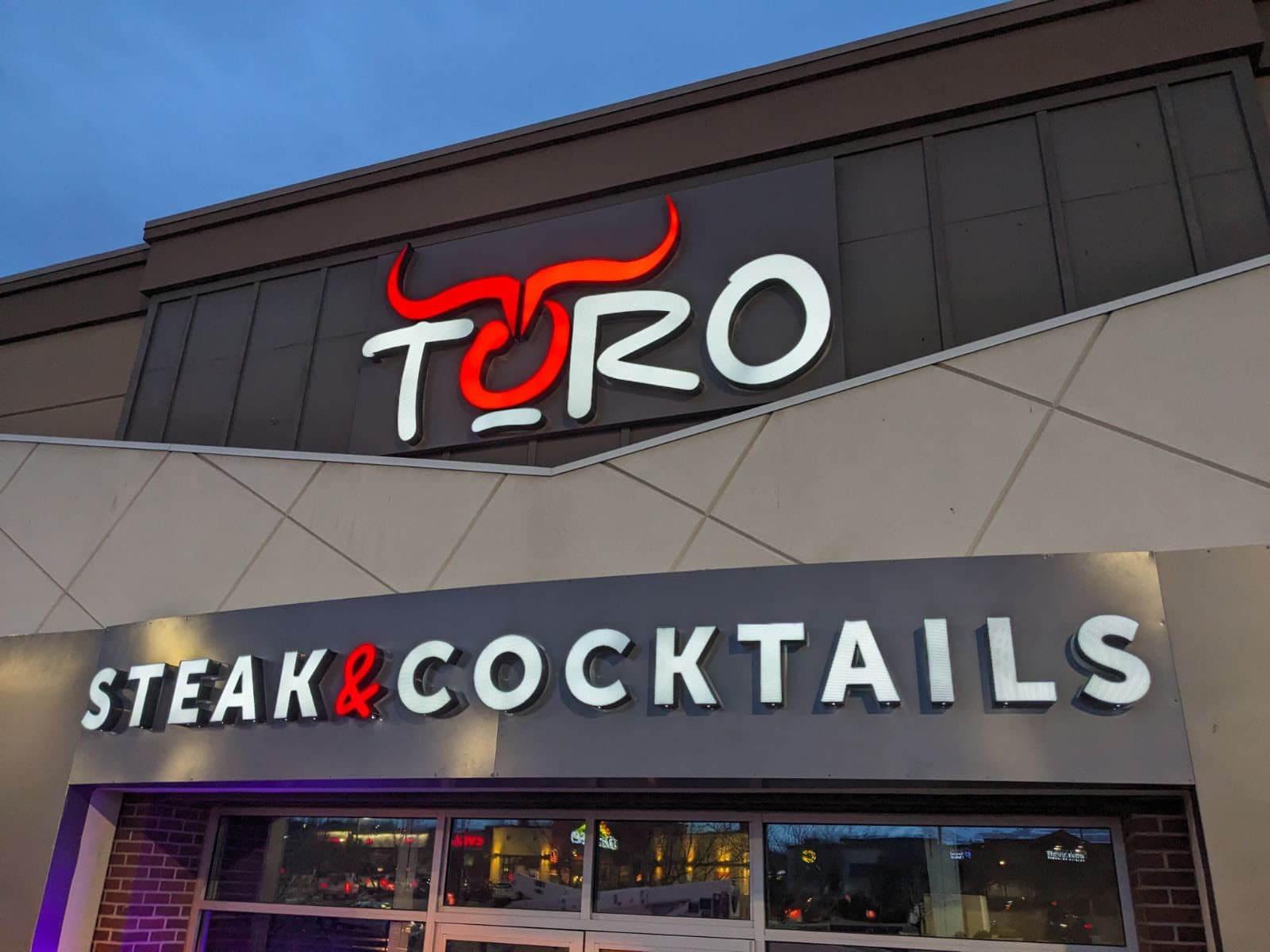 Illuminated exterior electric sign for Toro Steak and Cocktails.