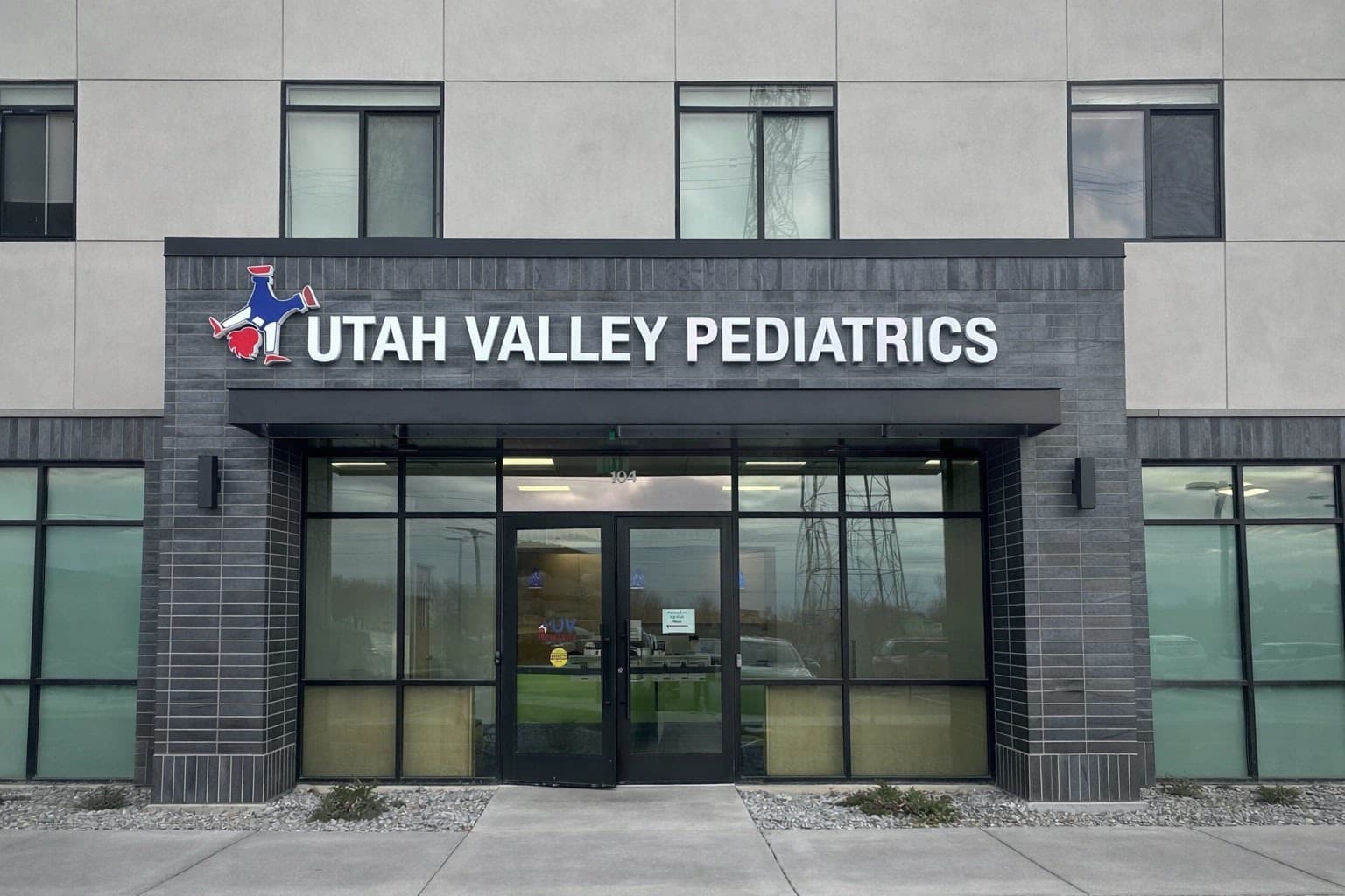 Exterior building signage for Utah Valley Pediatrics mounted above the glass entrance doors.