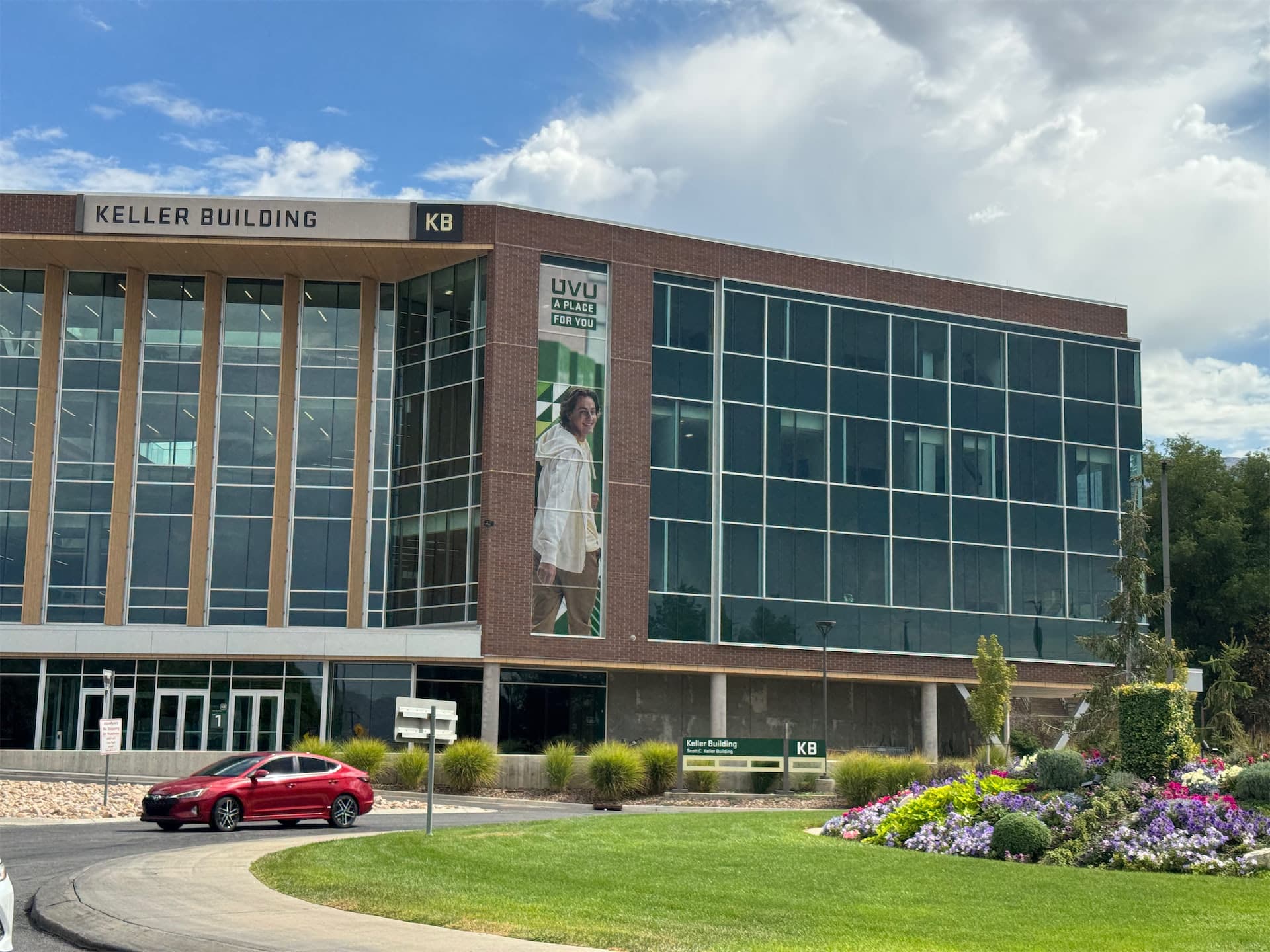 Exterior of the Keller Building at Utah Valley University featuring a large vertical window graphic.