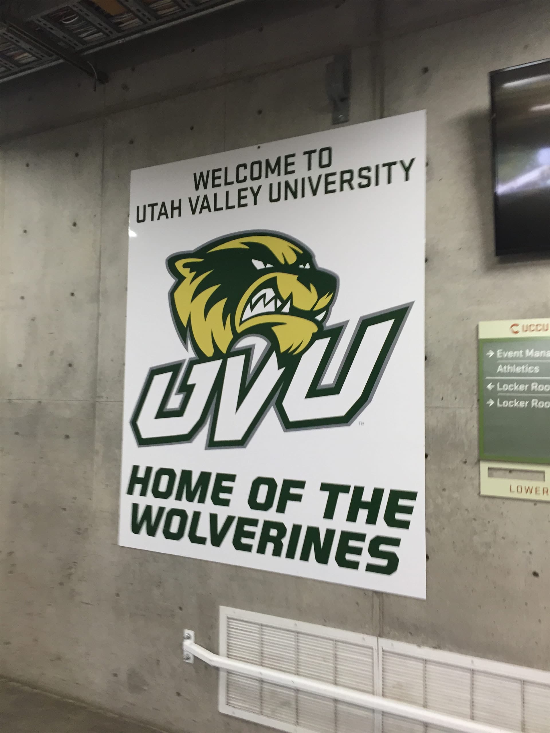 Large Welcome to Utah Valley University Home of the Wolverines wall sign mounted on a concrete wall.