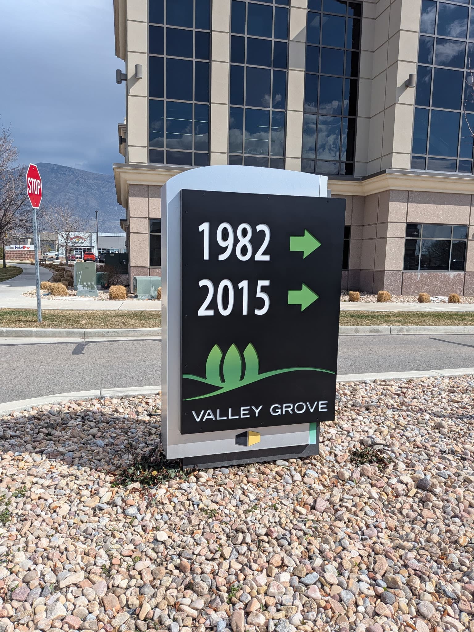 Valley Grove directional monument sign standing outside a modern office building.